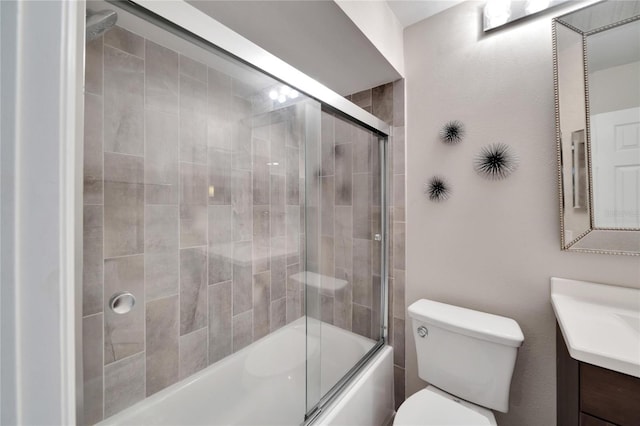 full bathroom with shower / bath combination with glass door, vanity, and toilet