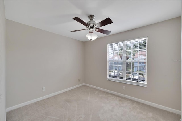 empty room with light carpet and ceiling fan