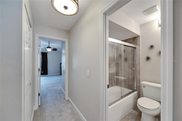 bathroom featuring combined bath / shower with glass door and toilet