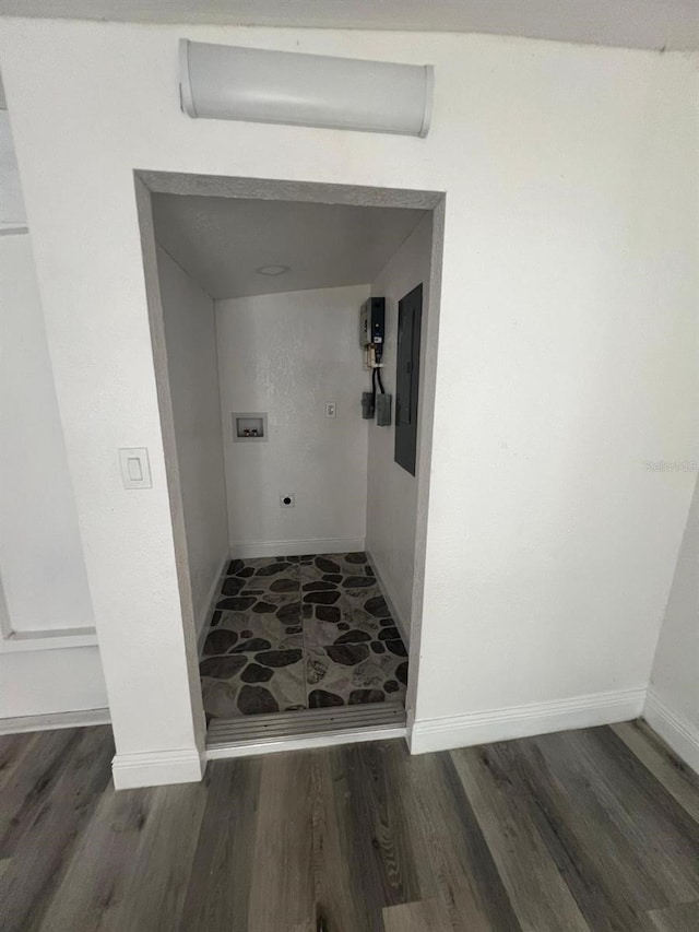 hallway featuring dark wood-type flooring and electric panel