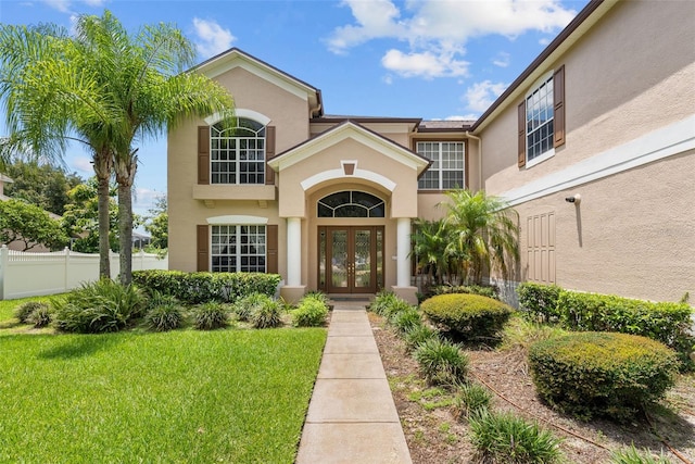 212 Excalibur Ct, Brandon, FL 33511 - property entrance with stucco siding, fence, a lawn, and french doors