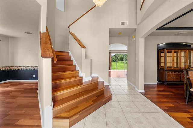 entryway featuring stairway, light wood-type flooring, visible vents, and baseboards