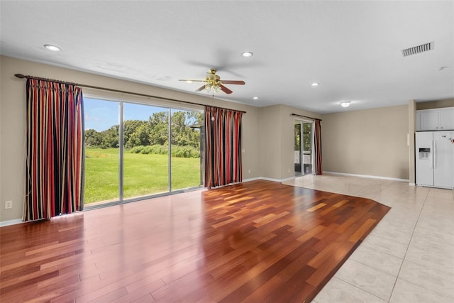 unfurnished living room with ceiling fan, recessed lighting, visible vents, baseboards, and light wood finished floors