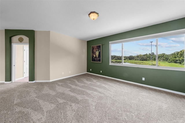 empty room with carpet and baseboards