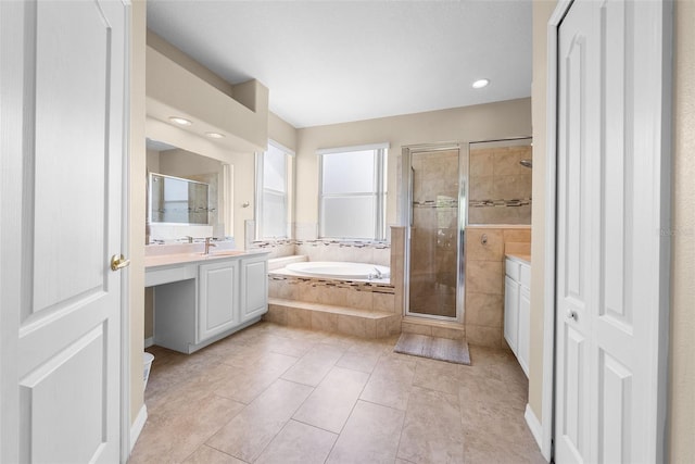 full bath with a stall shower, tile patterned floors, a garden tub, vanity, and a closet