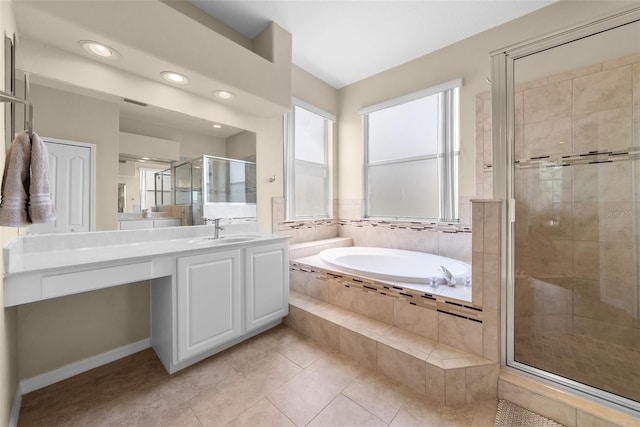 full bathroom with a stall shower, a garden tub, vanity, and tile patterned floors