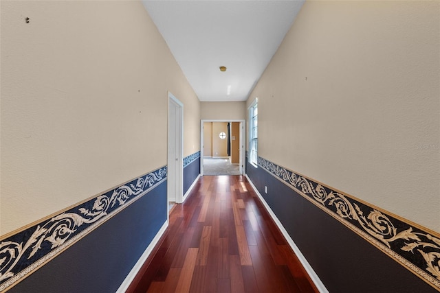 hall with baseboards and dark wood finished floors