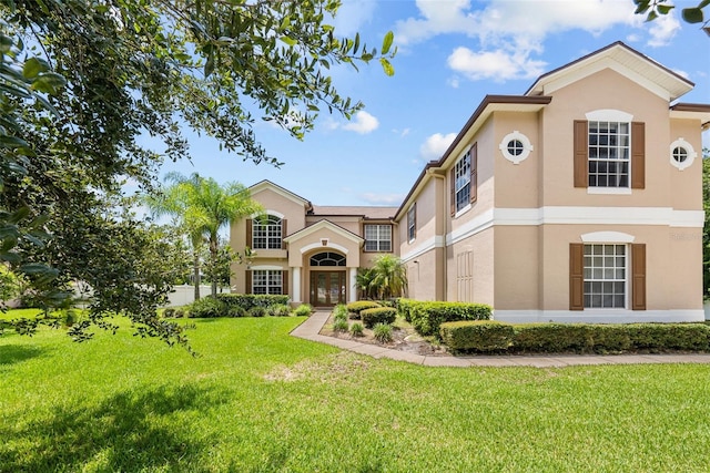 view of front of home featuring a front lawn and stucco siding