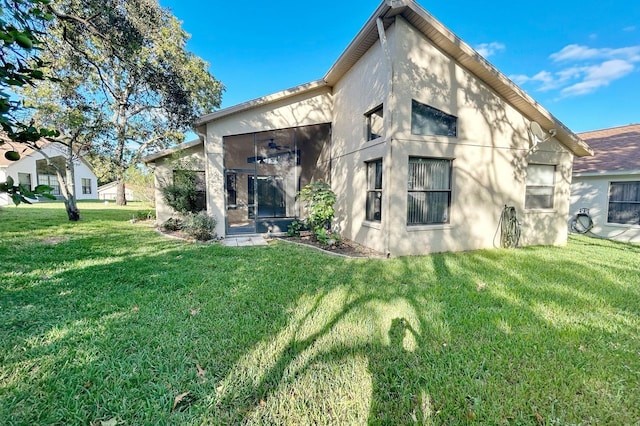 11416 Billingham Blvd, Spring Hill, FL 34609 - rear view of property featuring stucco siding and a yard