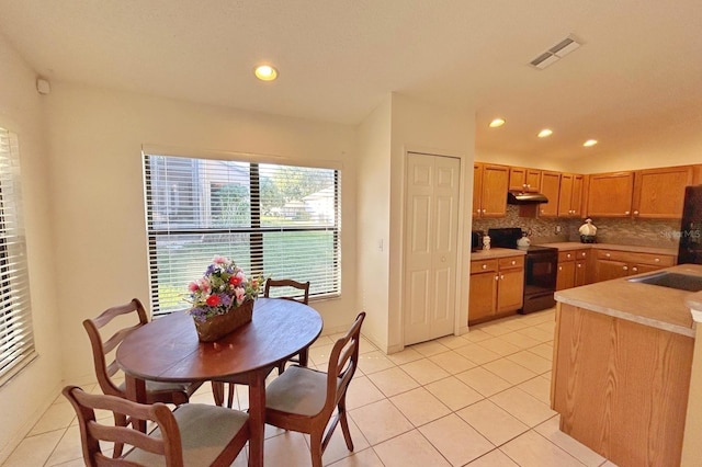 11416 Billingham Blvd, Spring Hill, FL 34609 - kitchen featuring black range with electric cooktop, tasteful backsplash, light tile patterned floors, recessed lighting, and under cabinet range hood