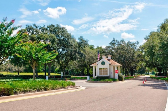 11416 Billingham Blvd, Spring Hill, FL 34609 - view of asphalt road with traffic signs, curbs, and view of scattered trees