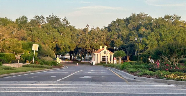view of road featuring curbs and traffic signs