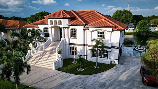 mediterranean / spanish-style house featuring a water view