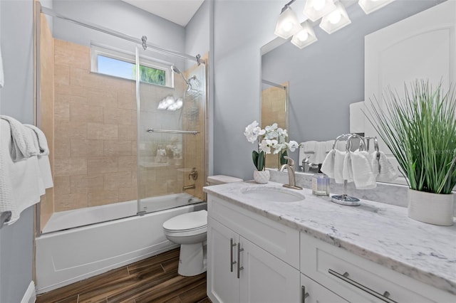 full bathroom with vanity, shower / bath combination with glass door, and toilet