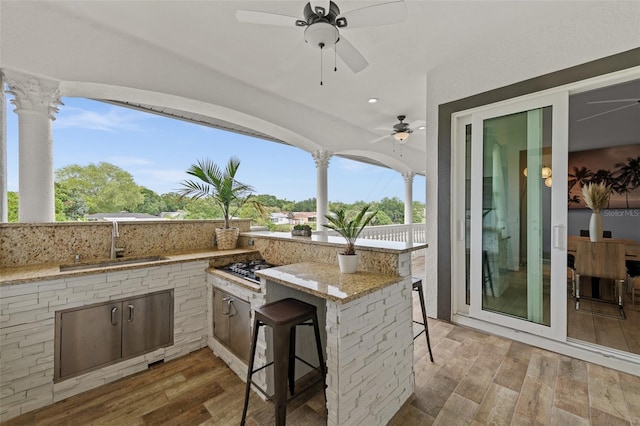 view of patio / terrace with a wet bar and ceiling fan