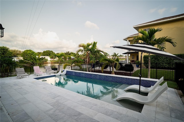 view of swimming pool with a patio