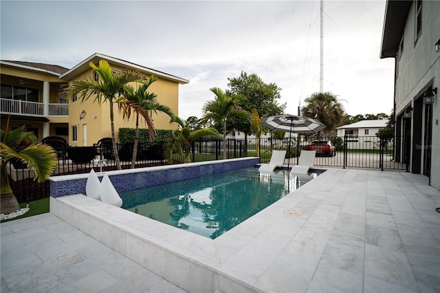 view of swimming pool featuring a patio area