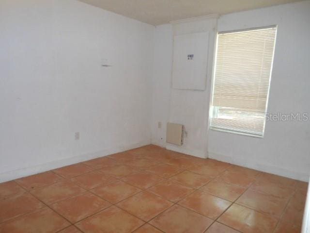 unfurnished room with light tile patterned flooring