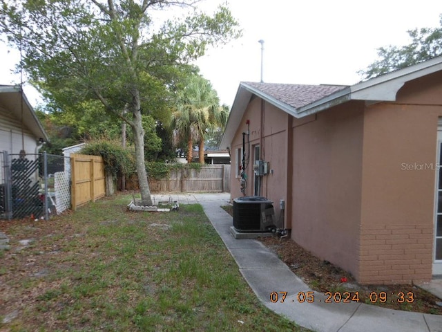 view of yard featuring cooling unit and fence