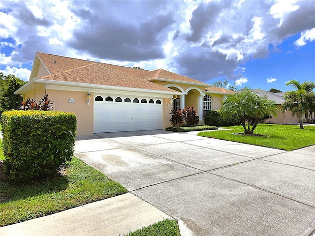 mediterranean / spanish-style house featuring a garage and a front yard