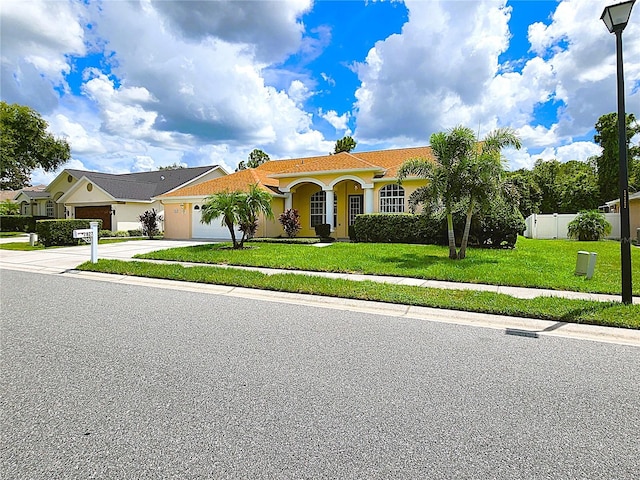 view of front of home featuring a garage and a front lawn