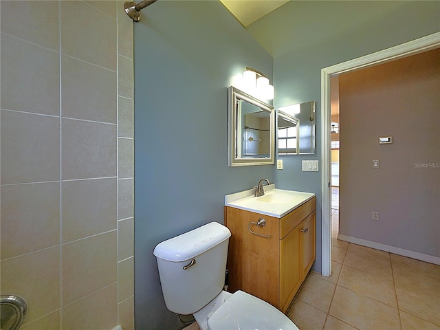 bathroom with tile patterned flooring, toilet, vanity, and vaulted ceiling