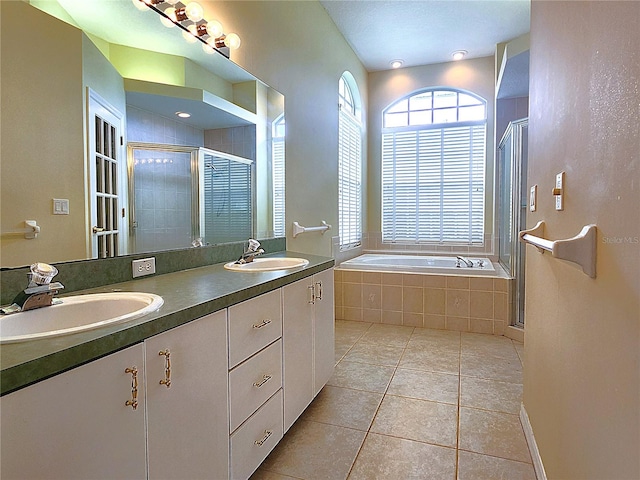 bathroom with vanity, tile patterned flooring, and plus walk in shower