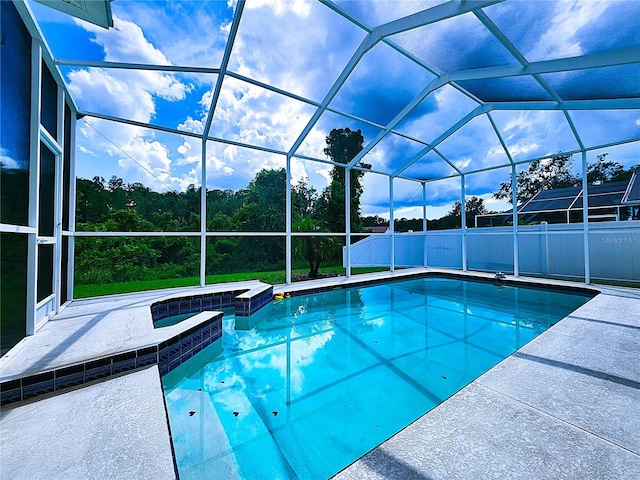 view of pool featuring a lanai and a jacuzzi