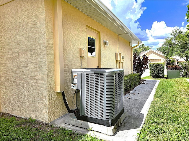 exterior details featuring cooling unit and stucco siding