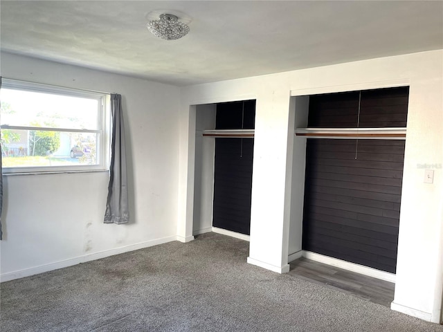 unfurnished bedroom with a closet and dark carpet