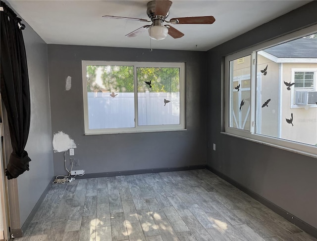 unfurnished room with ceiling fan and hardwood / wood-style flooring