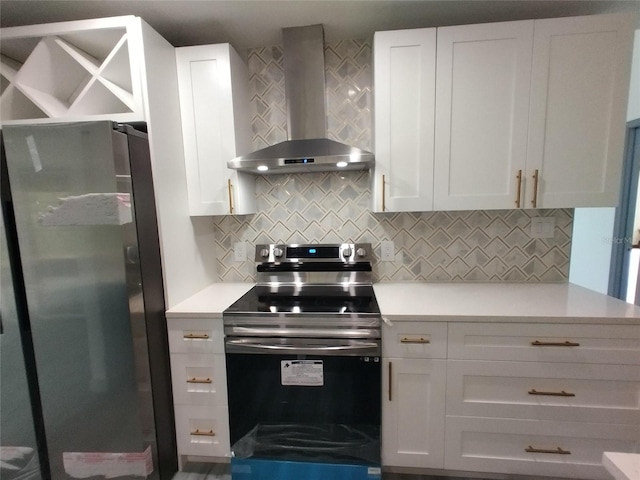 kitchen with white cabinetry, wall chimney exhaust hood, and appliances with stainless steel finishes