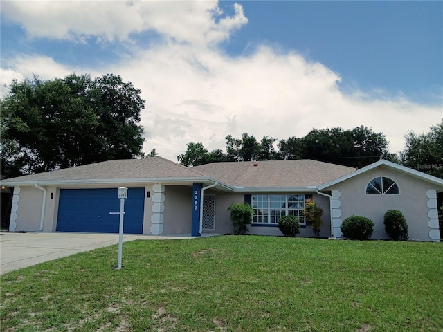 ranch-style home featuring a garage and a front yard