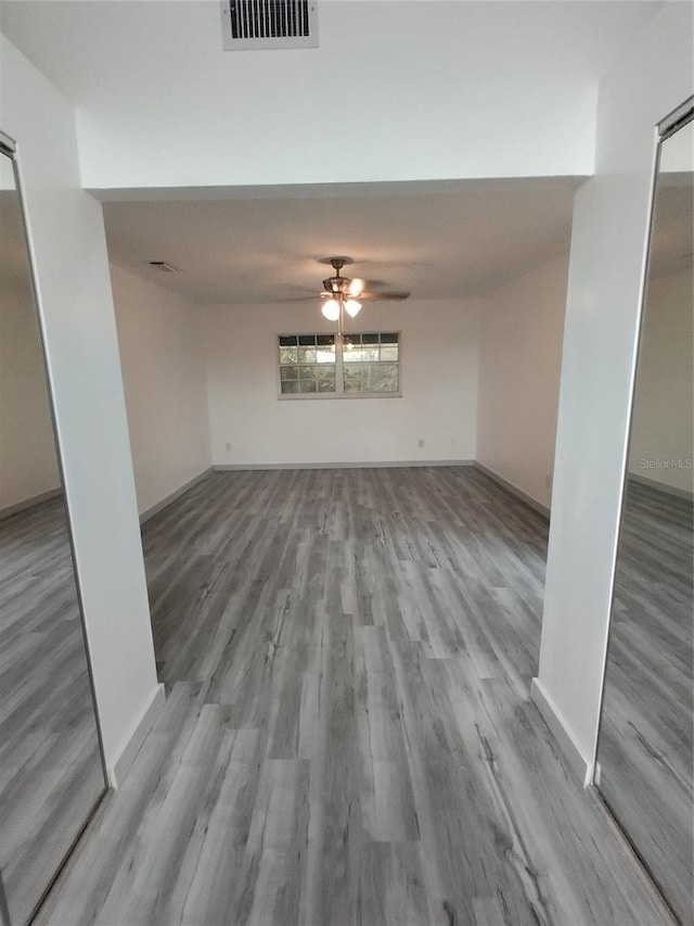 unfurnished living room featuring ceiling fan and light hardwood / wood-style flooring