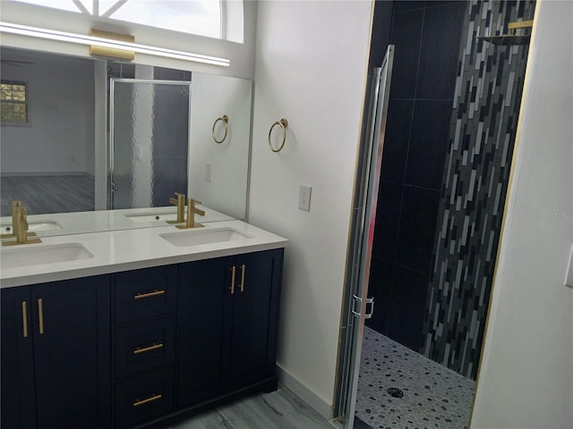 bathroom featuring walk in shower and vanity