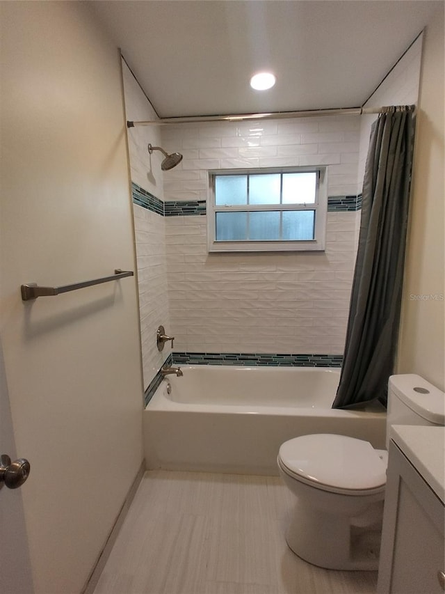 full bathroom with vanity, shower / bath combination with curtain, and toilet