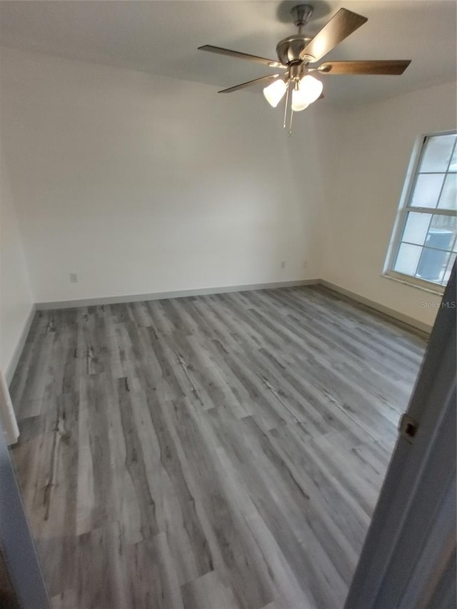 spare room with light hardwood / wood-style flooring and ceiling fan