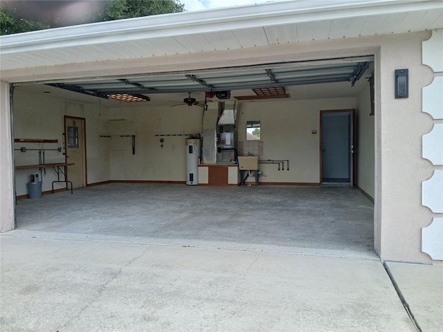 garage with sink, a garage door opener, electric water heater, and ceiling fan