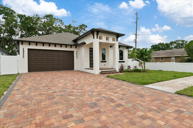 view of front of home with a garage and a front yard