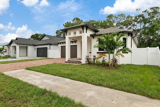 prairie-style home featuring a garage and a front yard