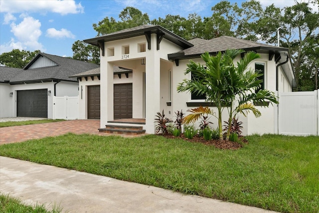 prairie-style home with a garage and a front yard