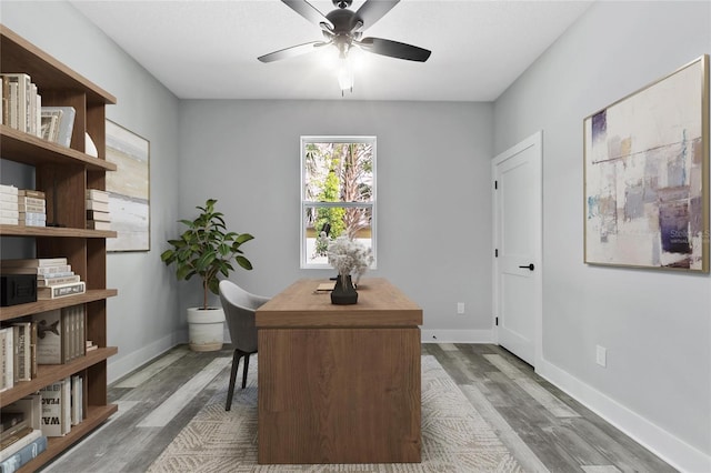 home office featuring hardwood / wood-style floors and ceiling fan