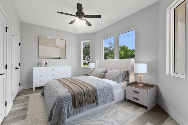 bedroom with ceiling fan and light wood-type flooring