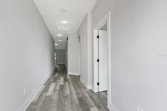 hallway with hardwood / wood-style floors