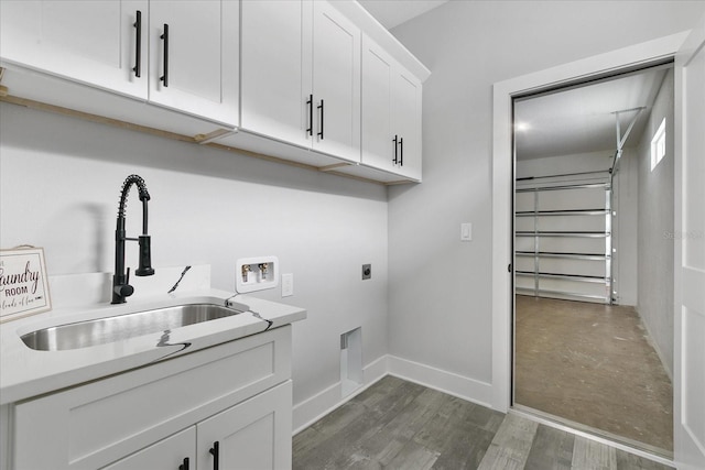 clothes washing area featuring sink, cabinets, washer hookup, dark wood-type flooring, and hookup for an electric dryer