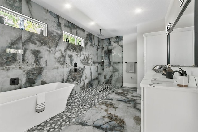 bathroom with independent shower and bath, vanity, and a textured ceiling