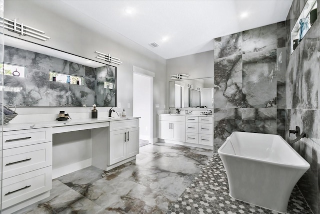 bathroom featuring vanity, tile walls, and a bathtub