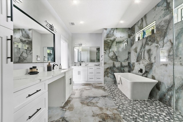 bathroom featuring vanity, shower with separate bathtub, and tile walls