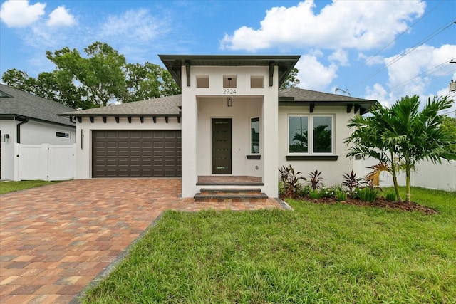 view of front facade with a garage and a front lawn