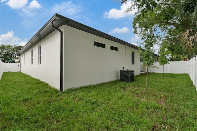 view of home's exterior with a lawn and central air condition unit